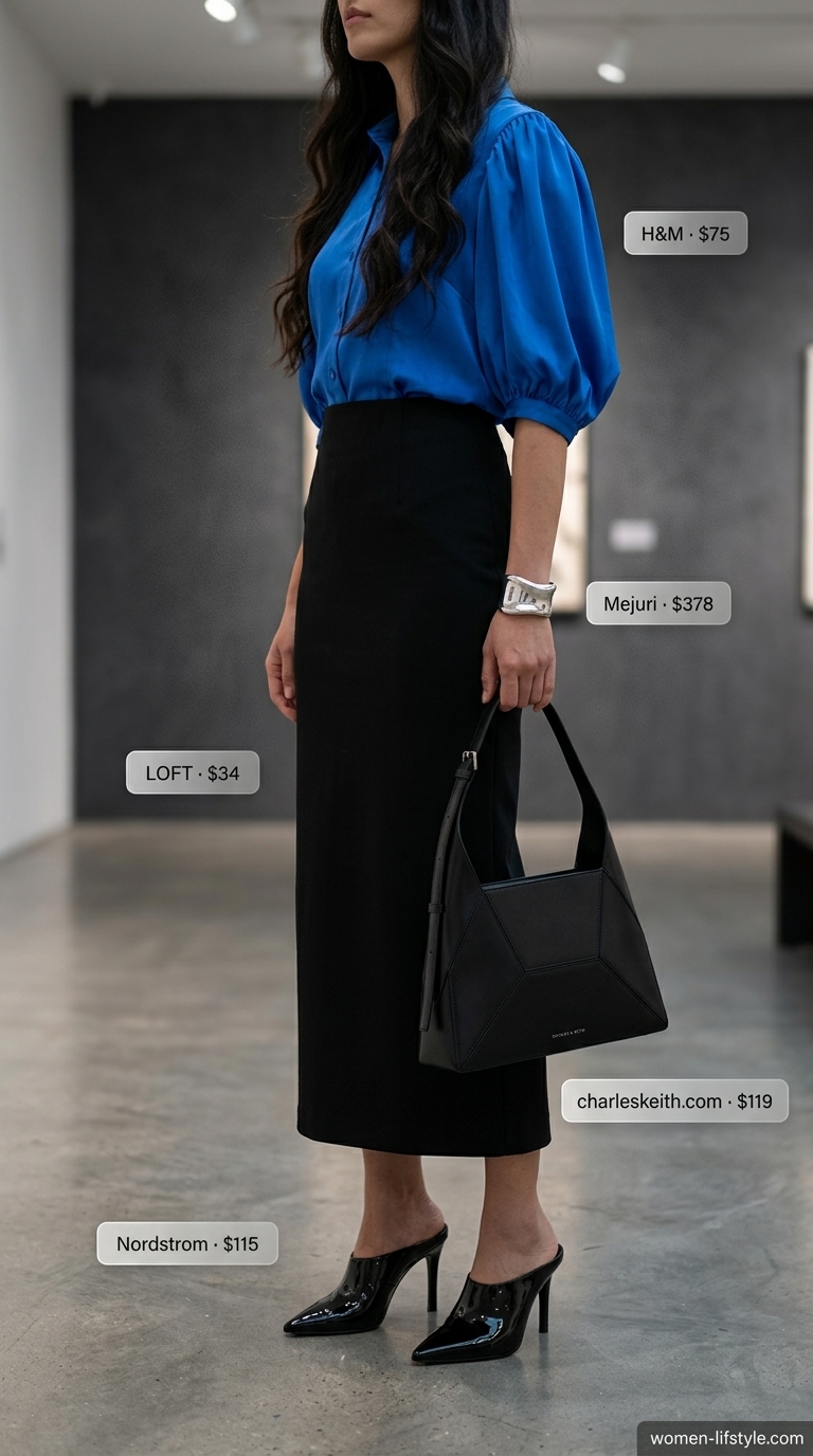 Bold Cobalt Blue Summer Blouse Gallery Opening 2026 Bold cobalt blue satin statement puff-sleeve blouse, a modern and artistic piece for summer blouses for women 2026. Paired with a black A-line midi skirt, black sculptural mules, and a geometric mini bag for an art gallery opening.
